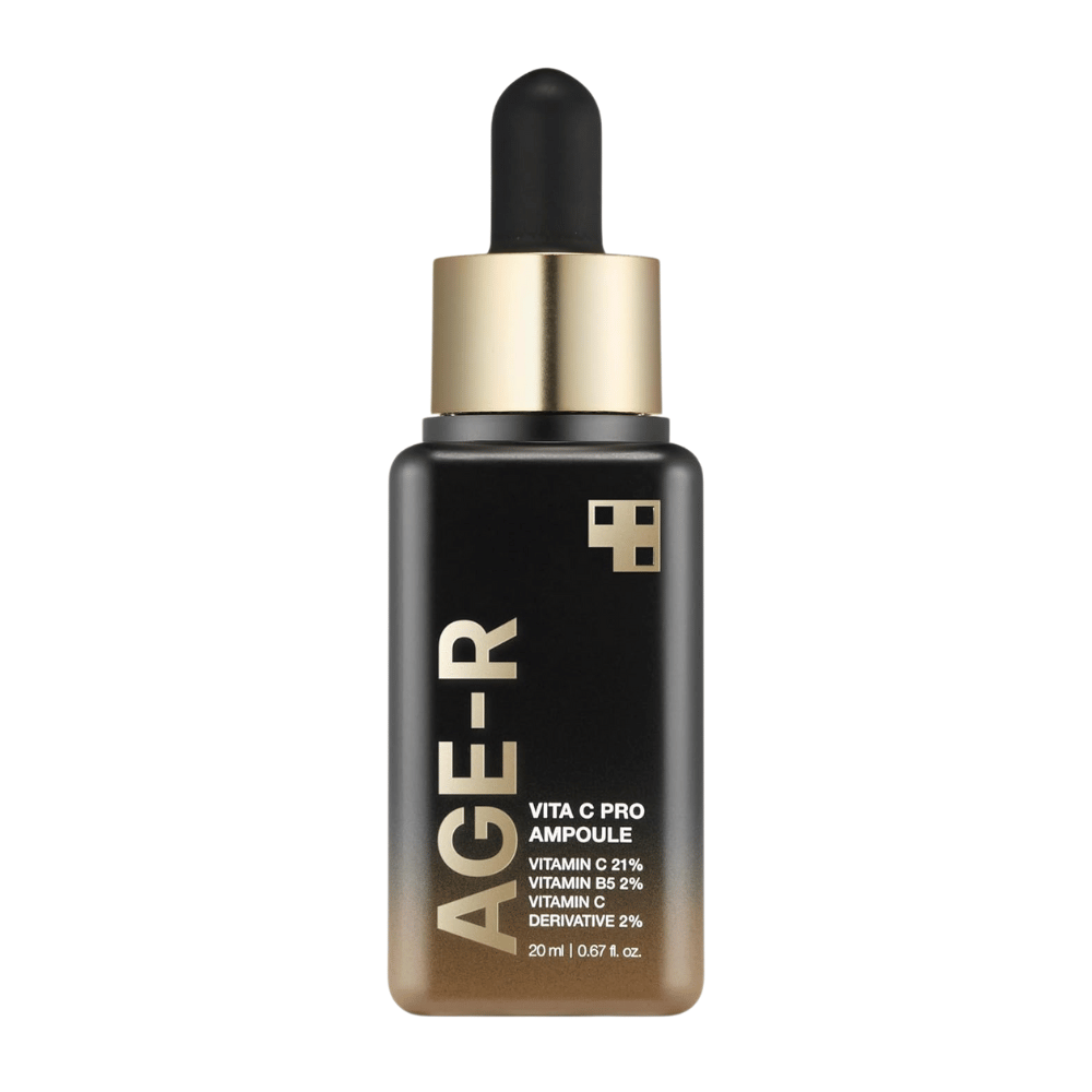 Botella de Medicube Age-R Vita C Pro Ampoule, un producto que contiene 21% de vitamina C, 2% de vitamina B5 y 2% de derivado de vitamina C. El empaque negro y dorado tiene un gotero para una aplicación precisa. El producto está diseñado para iluminar y mejorar la textura de la piel.