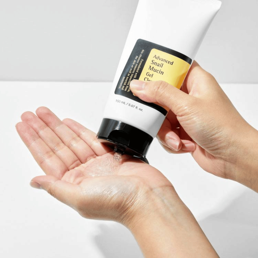 Mano aplica COSRX Advanced Snail Mucin Gel Cleanser – limpieza de gel suave con mucina de caracol que limpia en profundidad y mantiene el equilibrio de humedad de la piel.