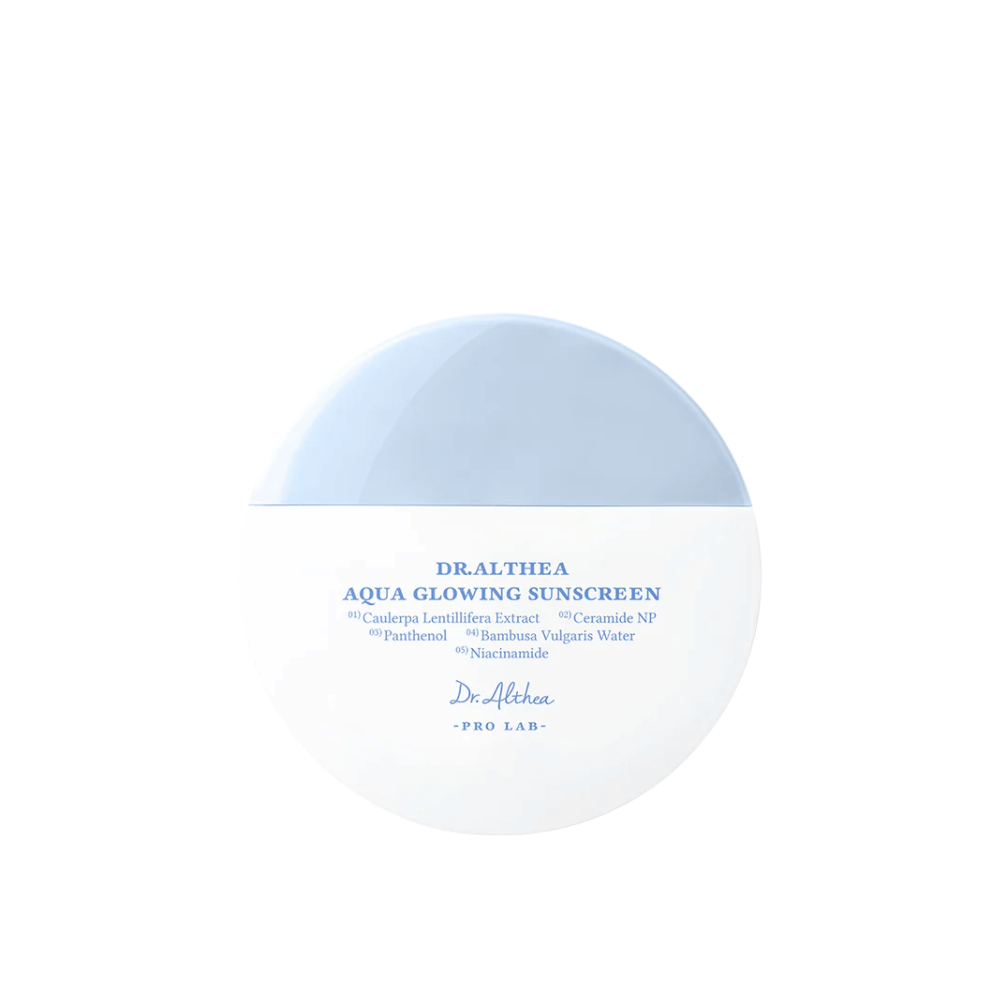 Imagen del producto de Dr. Althea Aqua Glowing Sunscreen – una crema solar redonda en un envase blanco y azul claro con texto en azul que destaca ingredientes hidratantes como niacinamida y ceramidas.