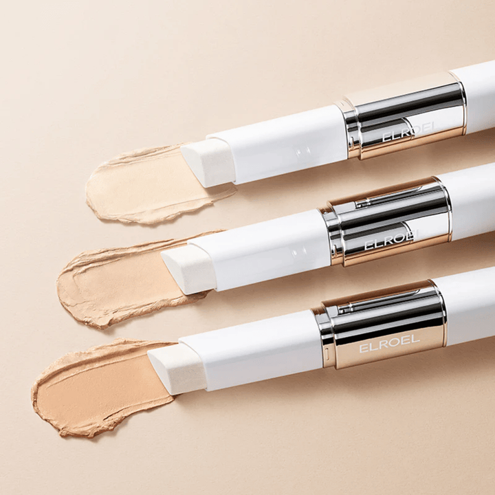 ELROEL Blanc Cover Cream Stick concealer con pincel integrado, varios sticks alineados que muestran el diseño del producto y la aplicación.