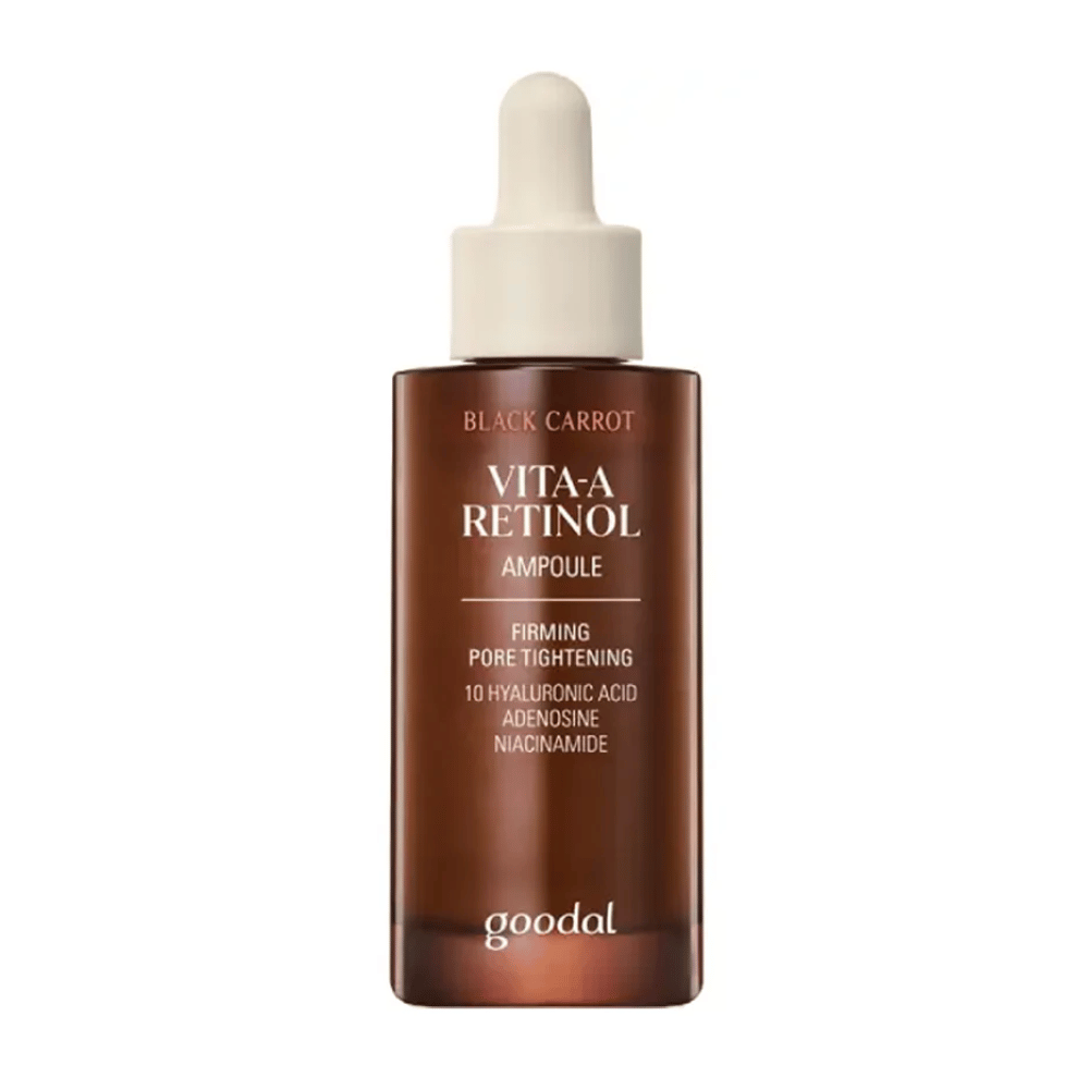 La botella con Goodal Black Carrot Vita-A Retinol Firming Ampoule se muestra. Tiene un gotero beige y una botella de color marrón oscuro. La etiqueta describe el producto como "Vita-A Retinol Ampoule" y menciona propiedades como "Firming Pore Tightening", así como los ingredientes 10% ácido hialurónico, adenosina y niacinamida.