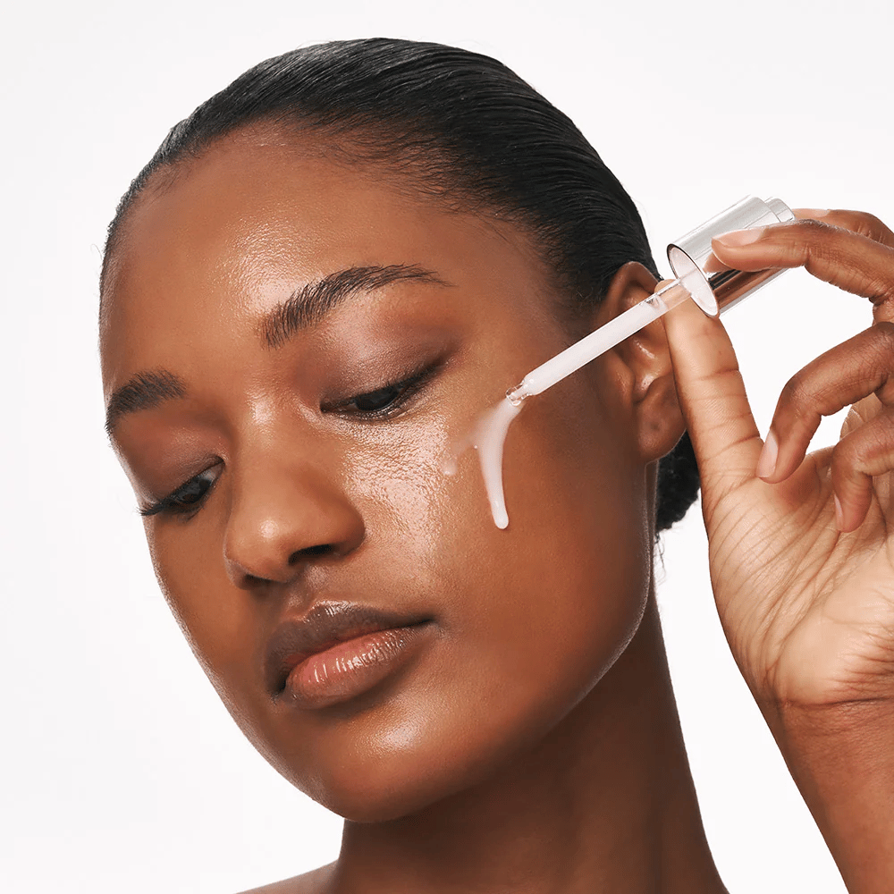 Persona aplica Deep Collagen Power Boosting Cream in Serum en la mejilla con un gotero. El suero proporciona una piel más firme, hidratada y luminosa.