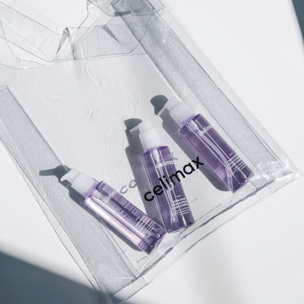 Tres botellas de Celimax Derma Nature Fresh Blackhead Jojoba Cleansing Oil en empaque lila, colocadas en una bolsa transparente con el logotipo 'celimax'.