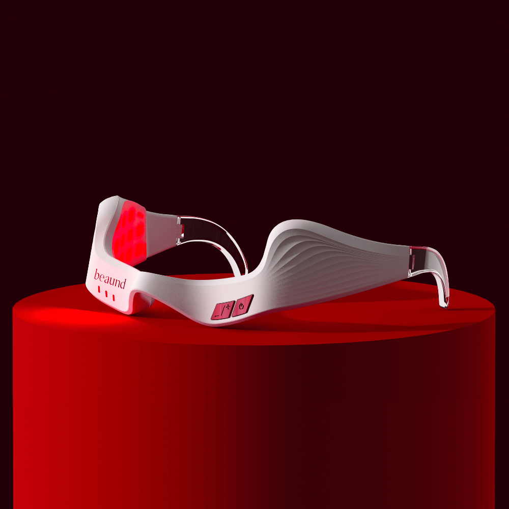 Imagen de producto que muestra Beaund Eye Rejuv con iluminación LED roja activa, colocada sobre un podio para una sensación exclusiva e innovadora.