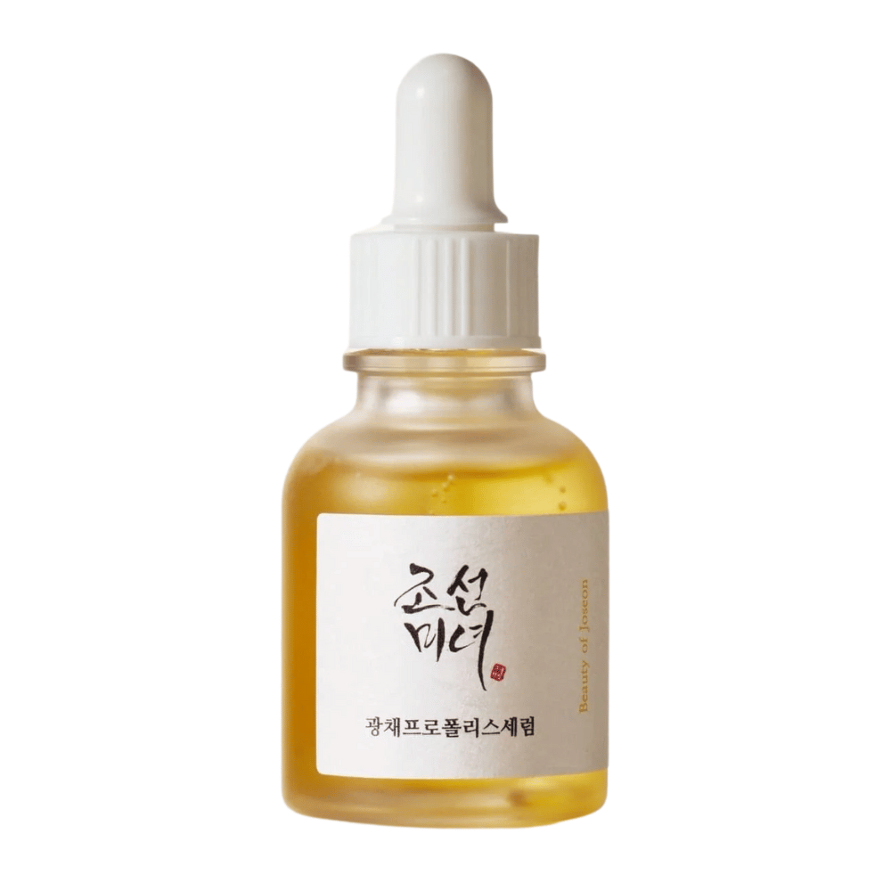 Botella de Beauty of Joseon Glow Serum con pipeta blanca y suero dorado, un producto iluminador con propóleo y niacinamida.