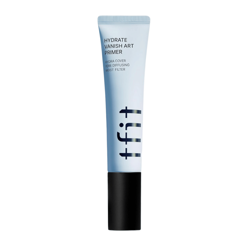 Tubo azul con tapa negra de TFIT, marcado "Hydrate Vanish Art Primer" – una primer hidratante con efecto alisador de poros y tecnología de filtro de humedad.