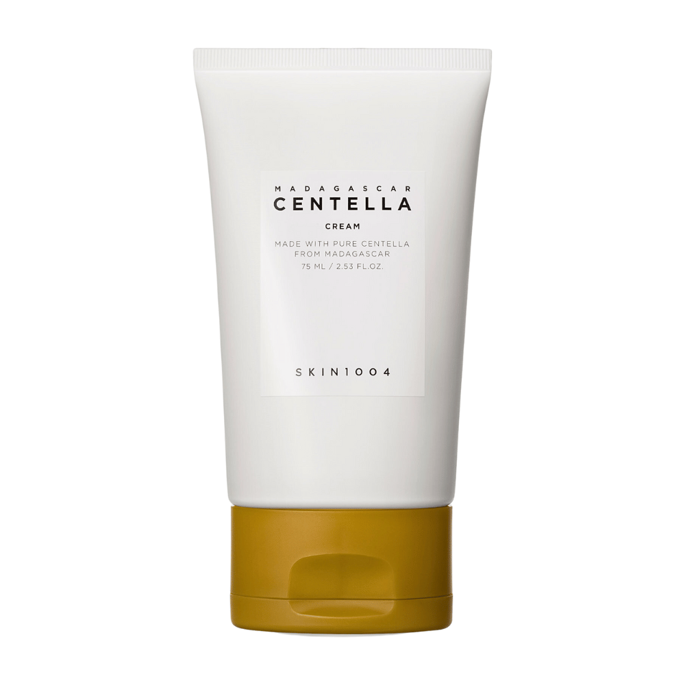 La imagen muestra un tubo de "Madagascar Centella Cream" de SKIN1004. Es una crema para la piel hecha de Centella pura de Madagascar y viene en un envase de 75 ml / 2.53 fl.oz. El producto está destinado a ser utilizado para el cuidado de la piel, para proporcionar nutrición e hidratación a la piel.