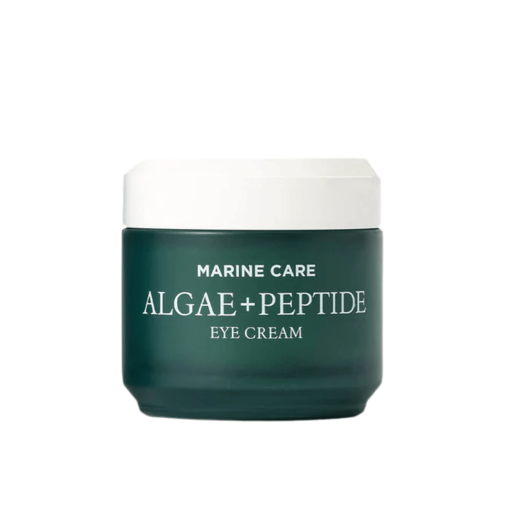 Heimish Marine Care Algae + Peptide Eye Cream en un tarro verde oscuro con tapa blanca. Una crema para ojos enriquecida con algas y péptidos para hidratar, iluminar y reducir las líneas finas alrededor de los ojos.