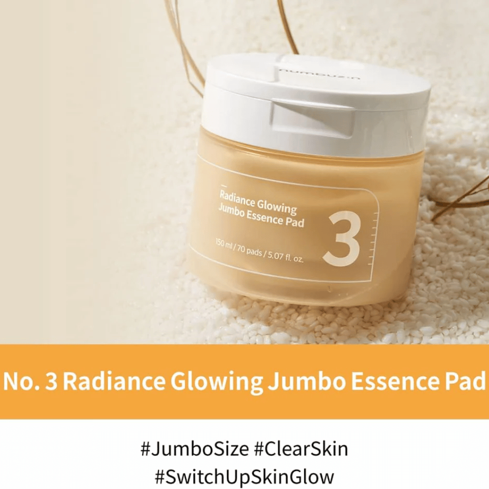 Frasco con numbuzin No. 3 Radiance Glowing Jumbo Essence Pad colocado sobre arroz, el texto en la imagen destaca el tamaño jumbo y el brillo de la piel.