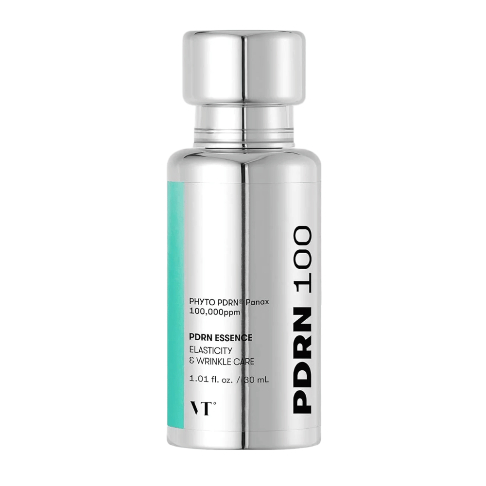 VT PDRN 100 Essence en una botella plateada con texto que indica contenido: 100,000 ppm PHYTO PDRN® Panax para elasticidad y cuidado de arrugas. La botella tiene una capacidad de 30 ml y un diseño elegante y brillante como un espejo.