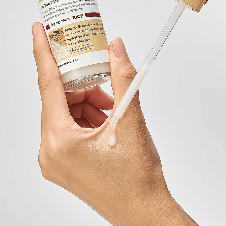 Primer plano de Dr.Melaxin Peel Shot Rice Ampoule aplicado con pipeta en la mano, ampolla exfoliante de textura ligera que se absorbe rápidamente y proporciona una piel hidratada y lisa.