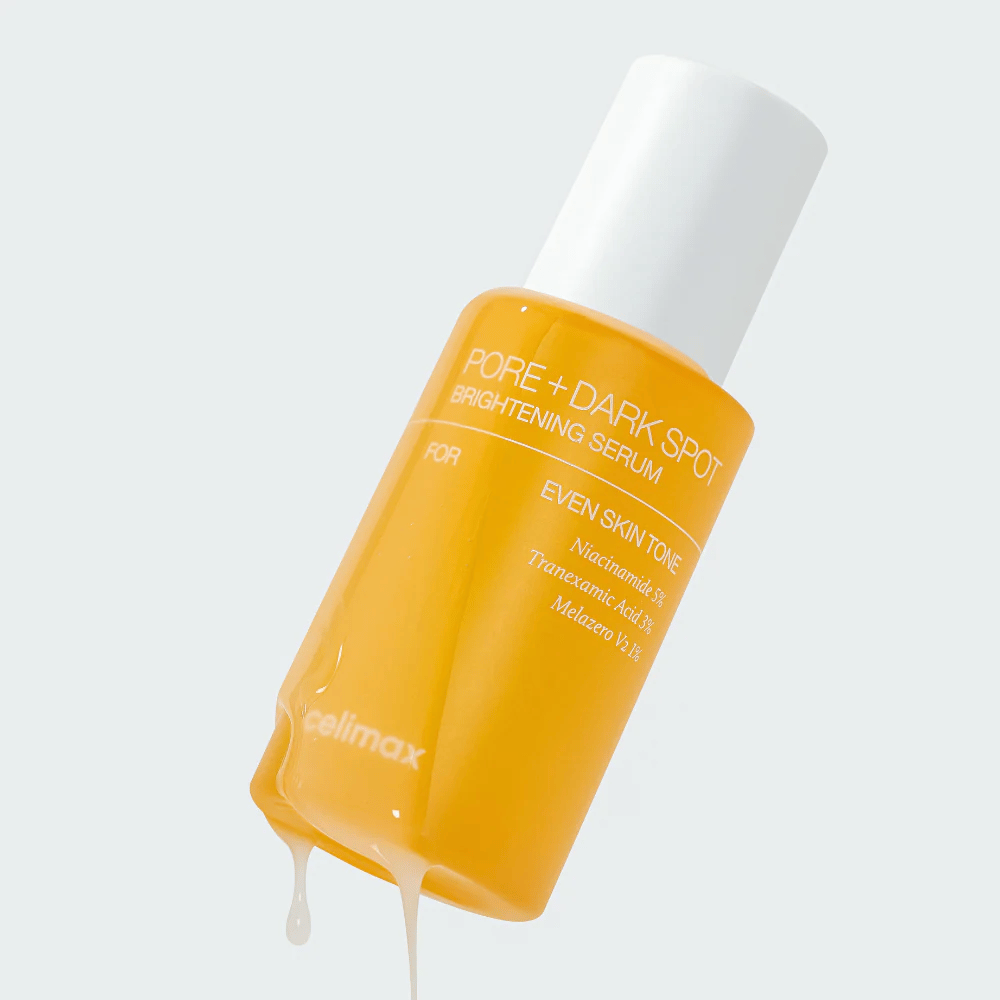 Celimax Pore + Dark Spot Brightening Serum en botella amarilla con tapa blanca, gotas de suero corren por la botella.