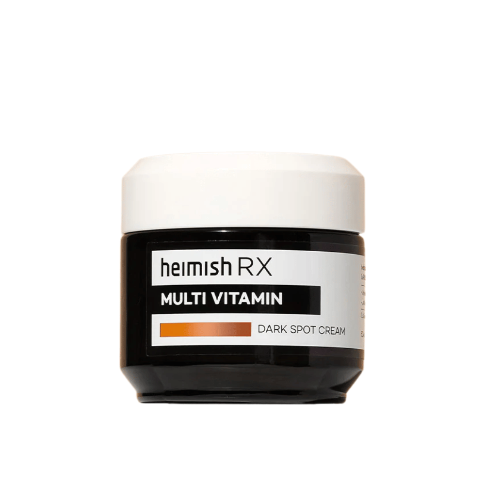 Heimish RX Multi Vitamin Dark Spot Cream en un elegante frasco negro con tapa blanca. Una crema facial enriquecida con multivitaminas, desarrollada para reducir manchas oscuras y unificar el tono de la piel.
