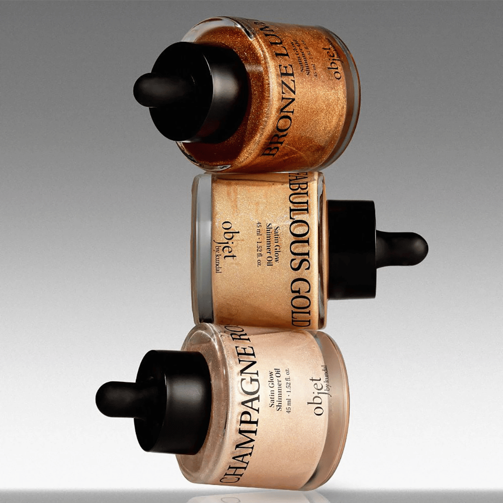 Objet by KUNDAL Satin Glow Shimmer Oil en Bronze Lumière, Fabulous Gold y Champagne Rose – aceites corporales brillantes con acabado luminoso.