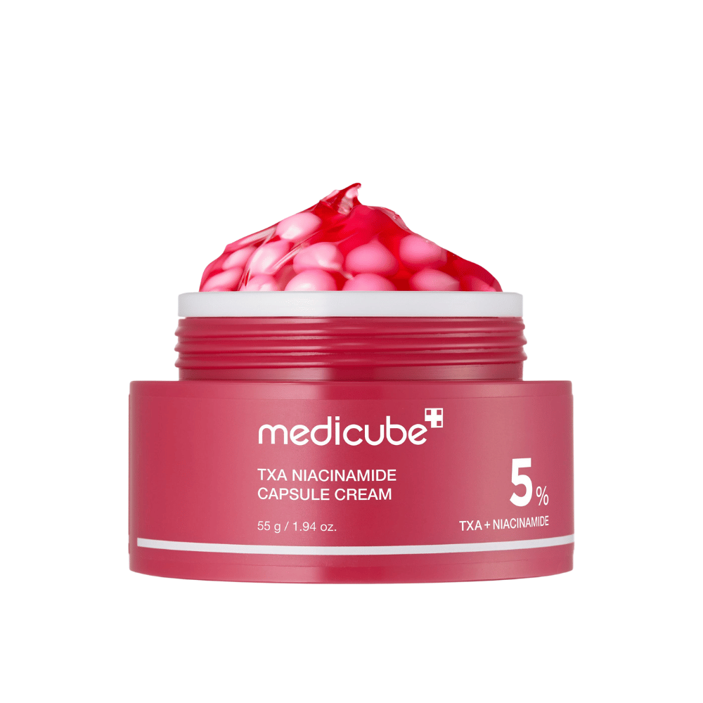 Medicube TXA Niacinamide Capsule Cream en frasco con cápsulas rosadas en forma de gel, mostrando una clara marca de producto con 5% TXA + Niacinamida.