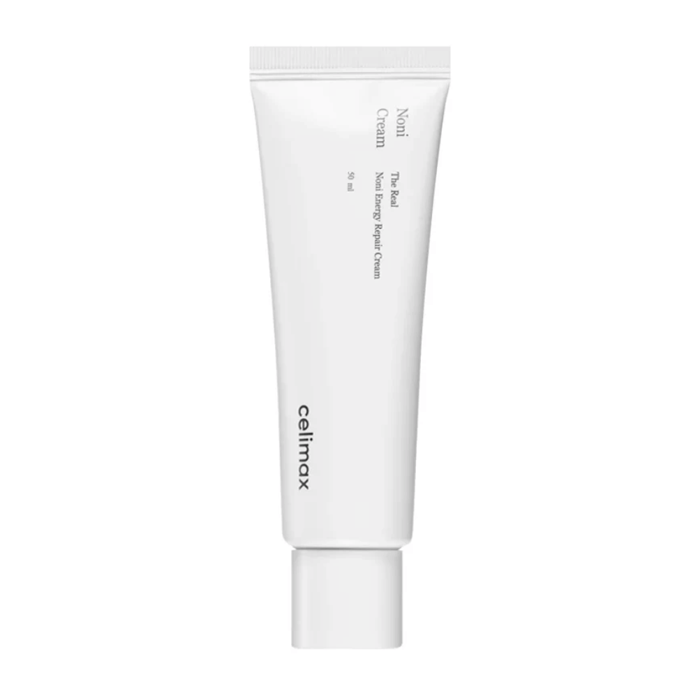 Celimax Noni Energy Repair Cream en un tubo blanco con texto negro. El producto está etiquetado como "The Real Noni Energy Repair Cream" y tiene un volumen de 50 ml.