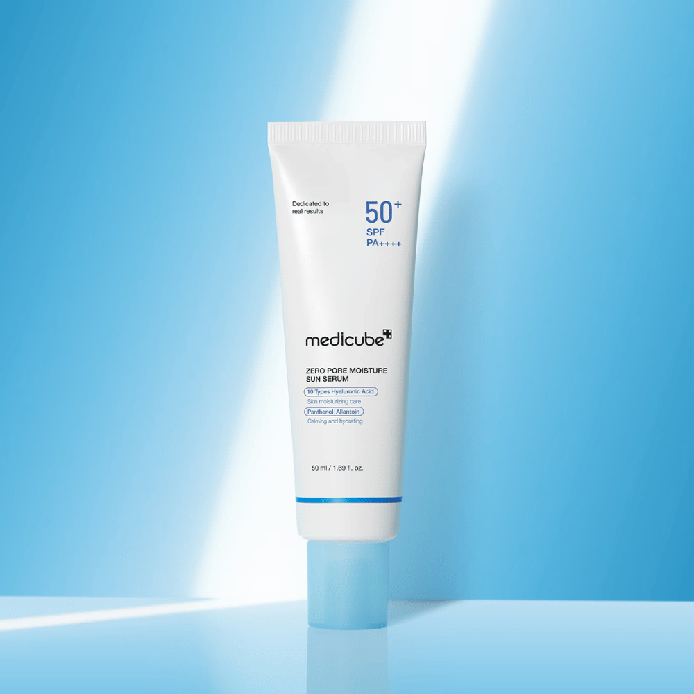 Medicube Zero Pore Moisture Sun Serum SPF50+ PA++++ presentado sobre un fondo azul. Sérum solar hidratante con ácido hialurónico, pantenol y alantoína para protección UV diaria y cuidado de la piel.
